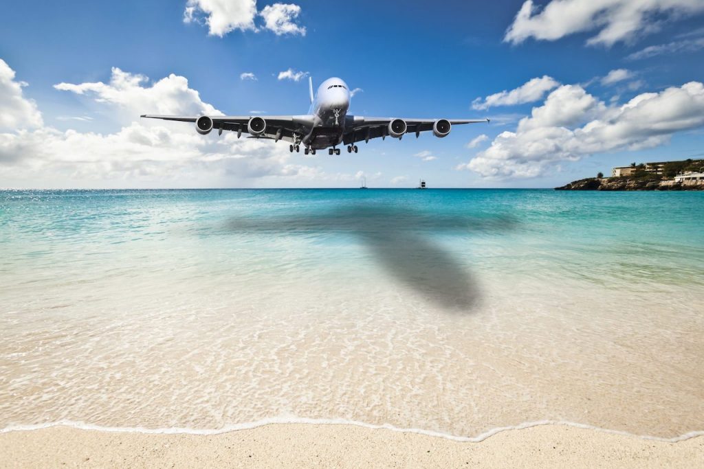 Aircraft landing at Princess Juliana International Airport over Maho Beach in Netherlands Antilles.
